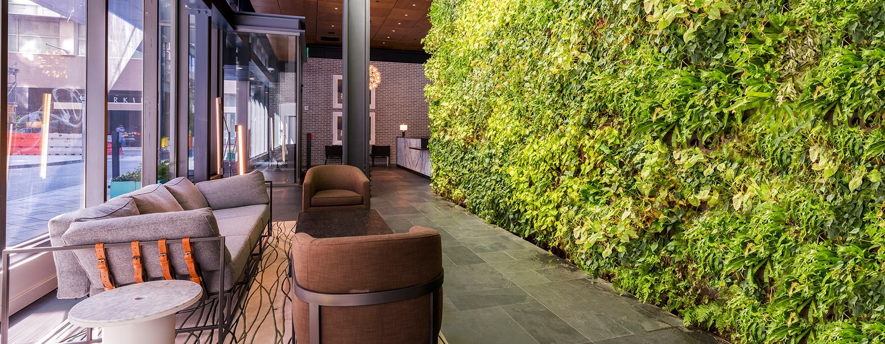 seating area beside large lush wall-turf and near lobby