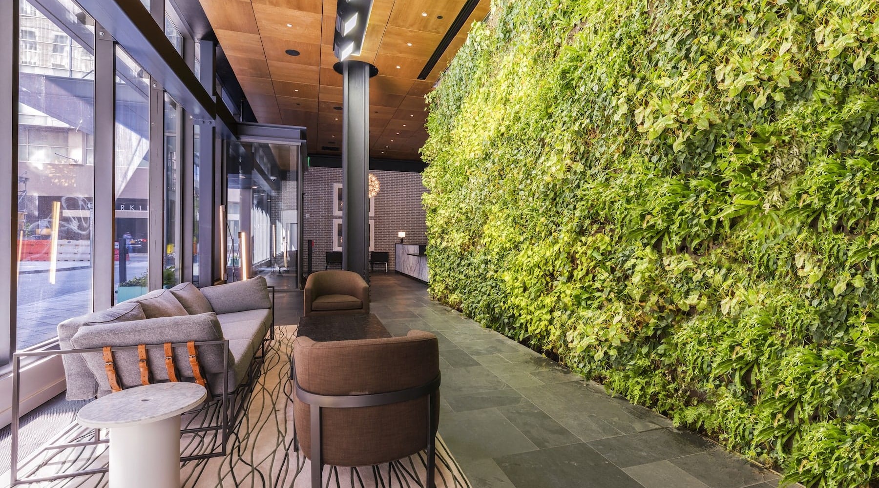 seating area beside large lush wall-turf and near lobby