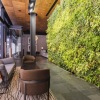 seating area beside large lush wall-turf and near lobby